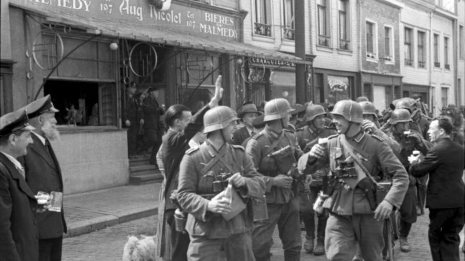 German troops entering the Eupen-Malmedy region of Belgium in May 1940, with civilians offering drinks