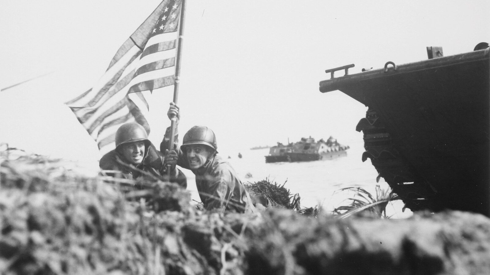 Two U.S. officers planting the American flag on Guam eight minutes after Marines and Army assault troops landed, July 20, 1944