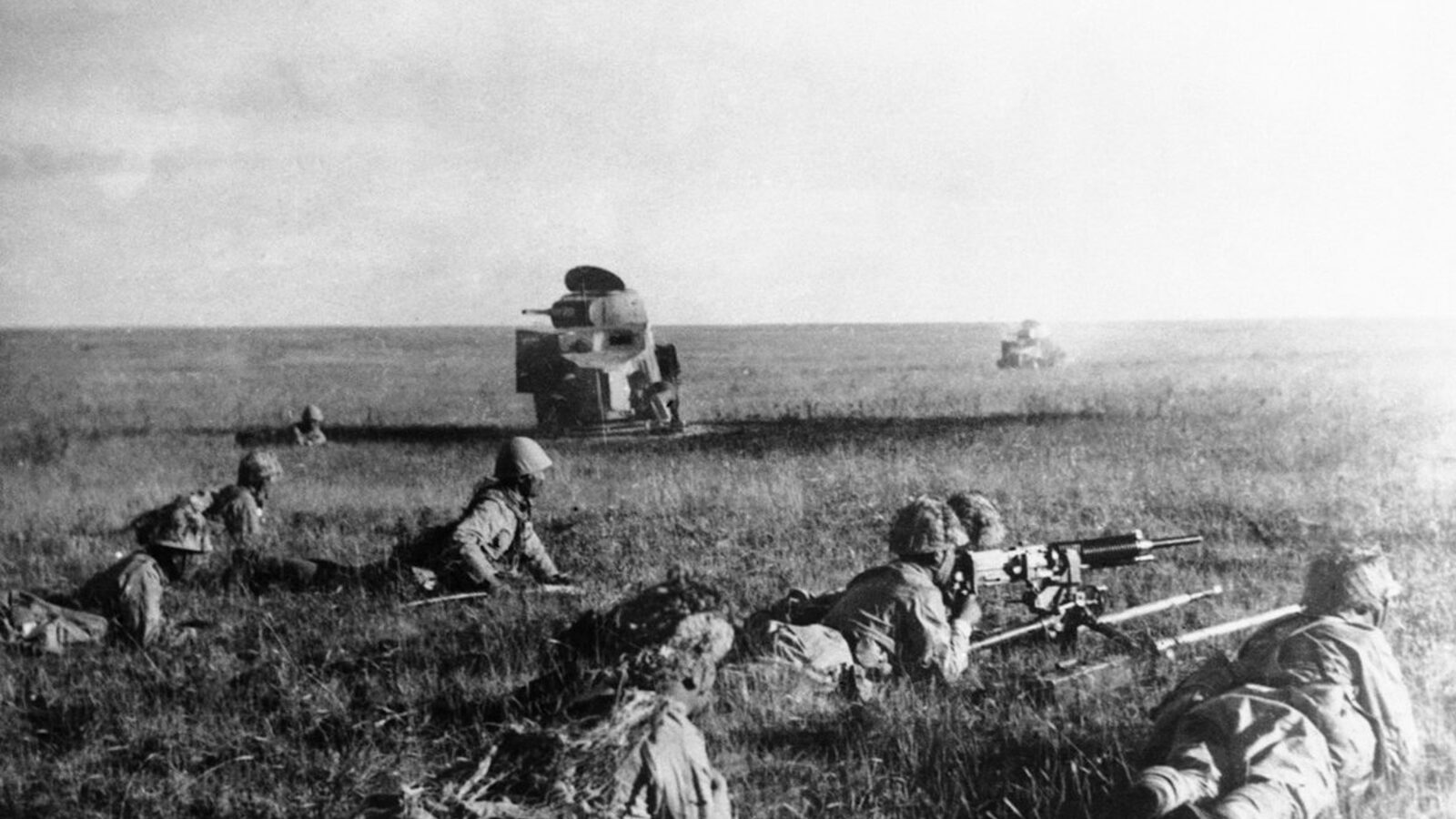 Japanese Kwantung Army soldiers advancing in front of wrecked Soviet armored cars during the 1939 Battles of Khalkhin Gol on the Manchukuo-Mongolian border
