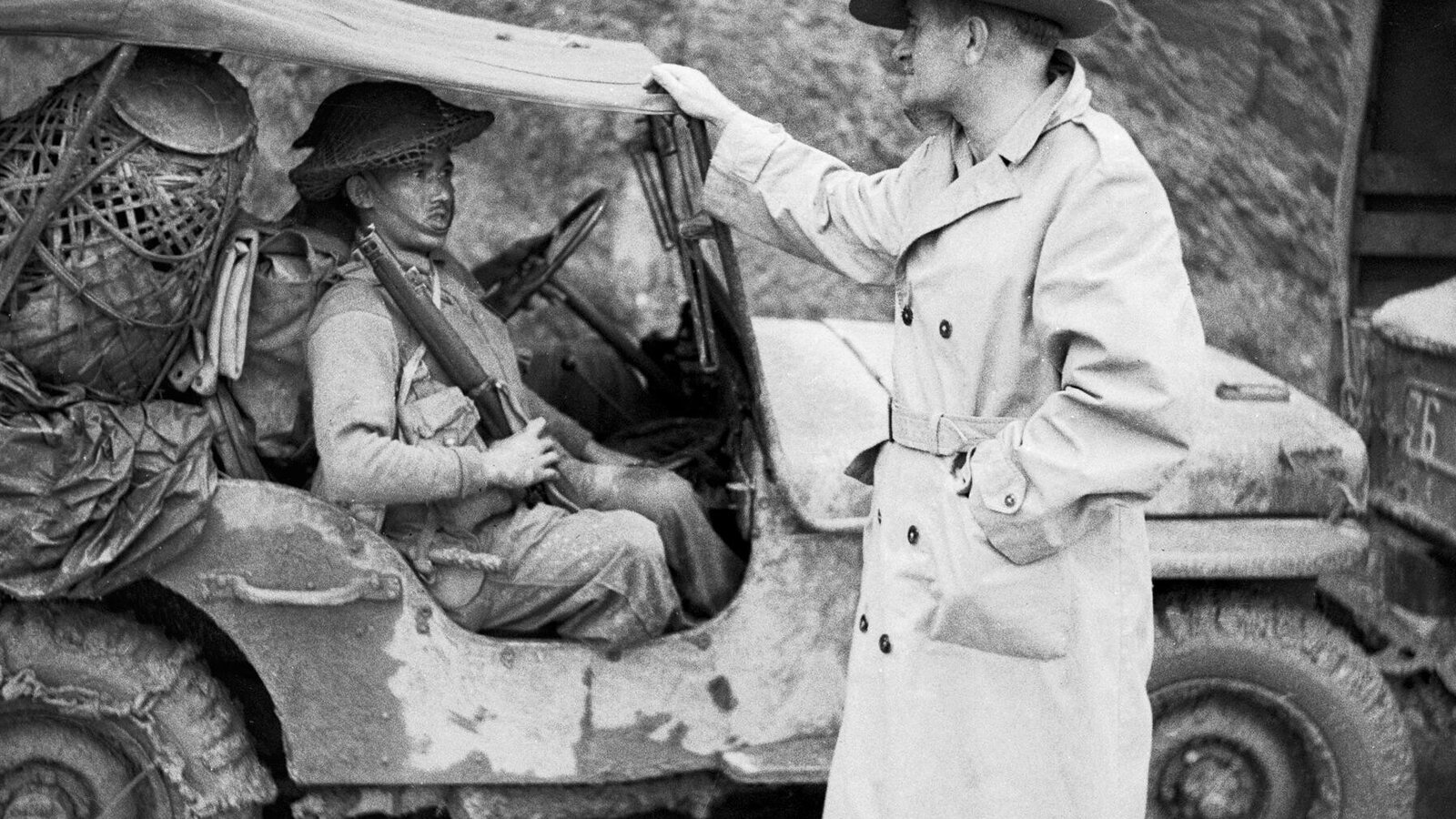Lieutenant General Sir William Slim, commanding British Fourteenth Army in Burma, talking with a Gurkha rifleman near Palel, November 1944