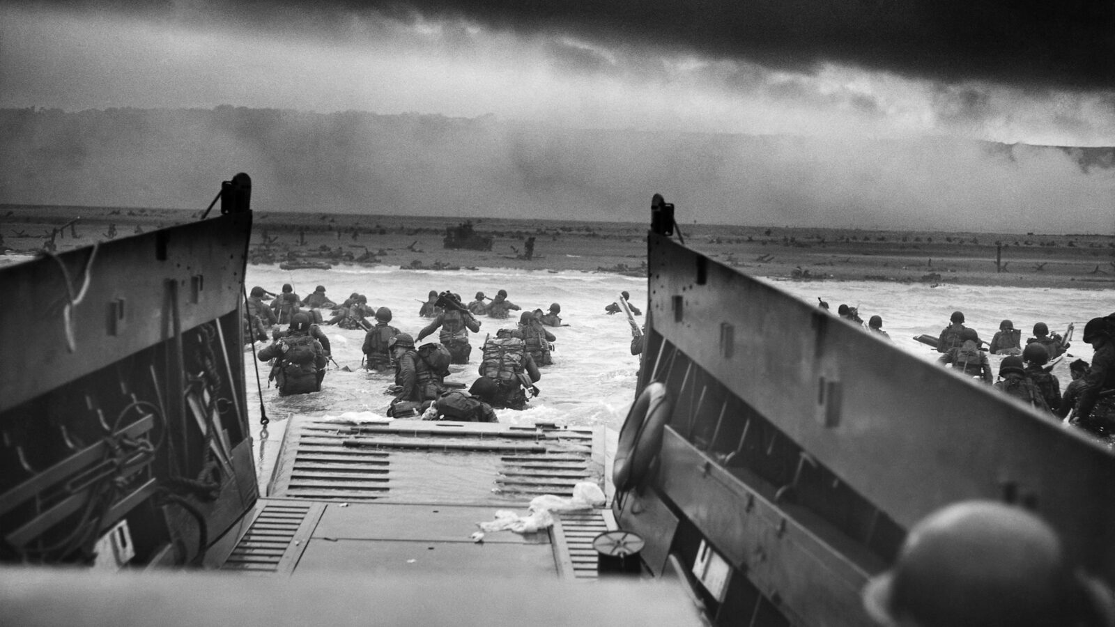 U.S. Coast Guard photograph 'Into the Jaws of Death' showing 1st Infantry Division troops disembarking from a landing craft onto Omaha Beach, June 6, 1944