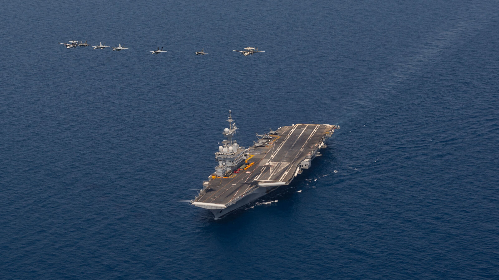 Aircraft fly over the French aircraft carrier Charles de Gaulle (R91) in the Red Sea, 15 April 2019