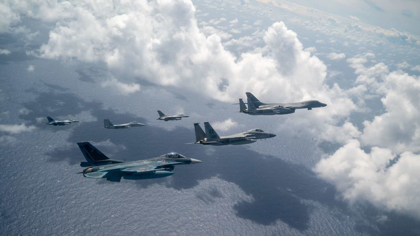 Japan Air Self-Defense Force F-2 fighters in formation with U.S. Air Force aircraft over Guam, Cope North 2023