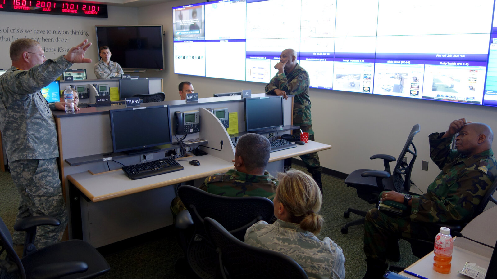 U.S. Army Col. Thomas Croymans shows Suriname Defense Forces members the South Dakota National Guard's Joint Operations Center at Camp Rapid, July 2015